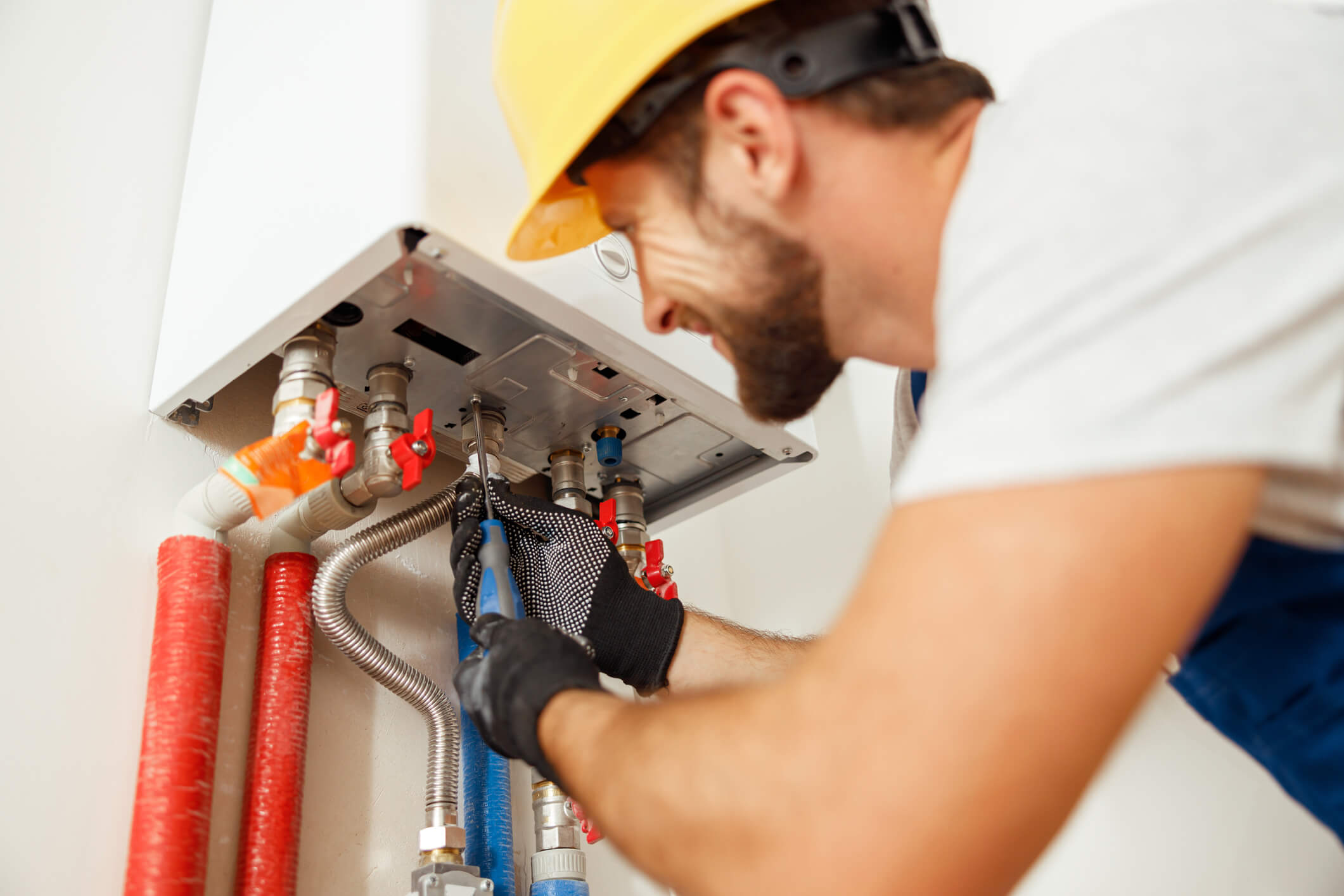 man fixing water heater